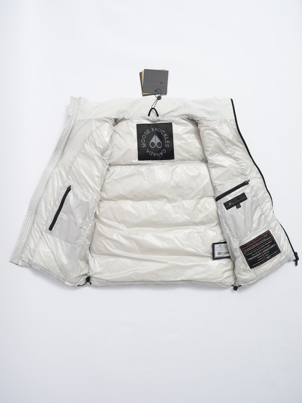 Moose Knuckles Puffer Vest in White with Stand Collar and Metallic Logo